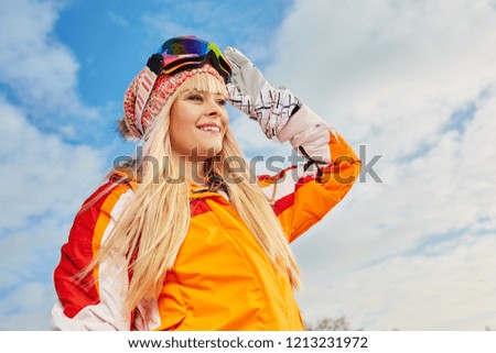 Picture of happy young lady snowboarder 