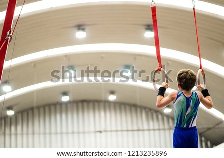 Portrait of little kid gymnast in a championship.