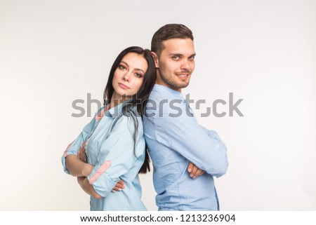 Relationship and people concept - Couple posing back to back on white background