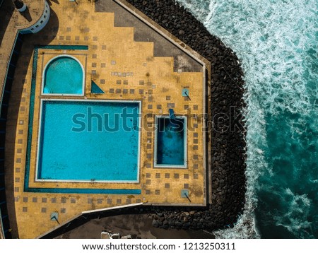 Aerial view from swimming pools near the ocean. Drone shot