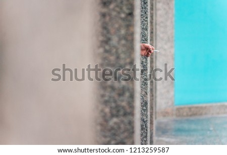 A man with a lit smoke in hand, in Toronto city Royalty-Free Stock Photo #1213259587