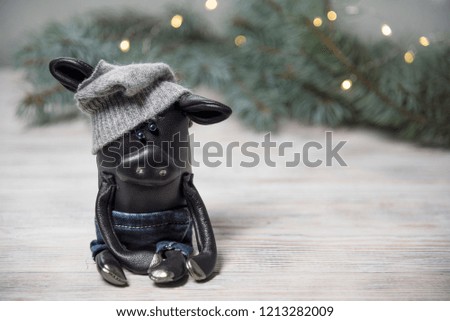 
Toy pigs on the background of a Christmas tree and lights. Chinese 2019 new year