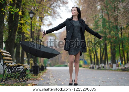 girl with umbrella. bad weather. walk in the autumn. a walk in the rain the Park. the girl with umbrella in a raincoat.