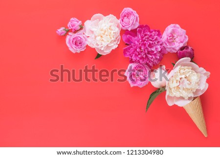 Waffle cone with white and pink peonies flower bouquet on pink red background