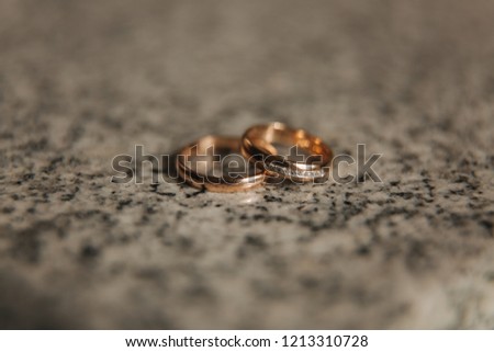 Wedding rings on table. Gold rings with diamond on sun. Wedding accsessories. macro