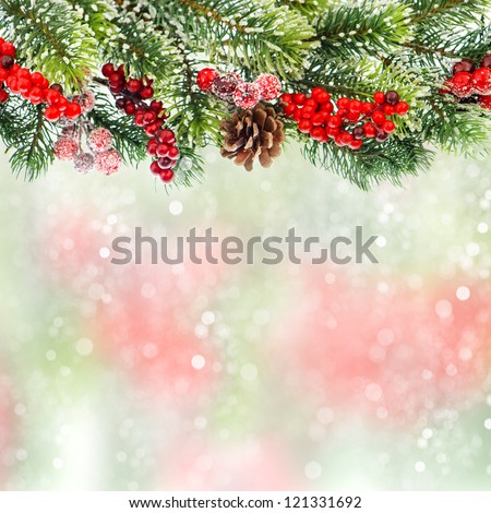 christmas tree branch decoration with red berries on blurred background