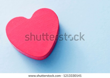 Red heart on a blue background, top view