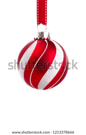 A Delicate Red and White Glittery Christmas Ornament Hanging on a Ribbon