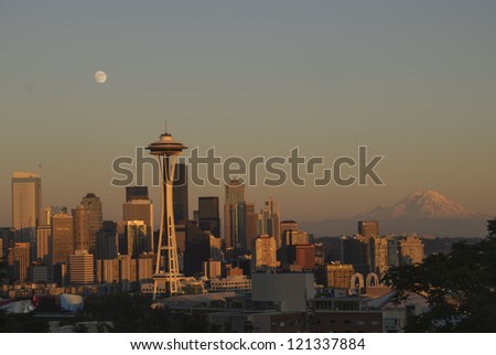 Seattle Skyline with full moon and Mt. Rainier at sunset.