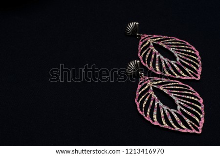 Earring in shape of feather, costume jewelry.