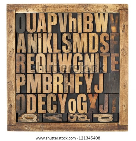 random letters of alphabet - vintage letterpress wood type blocks in rustic box isolated on white Royalty-Free Stock Photo #121345408