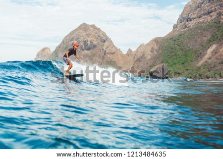 surfer in the ocean on the island of Sumbawa