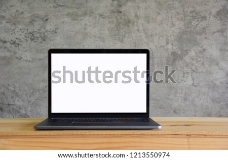Blank screen Laptop on wooden table in room Loft style