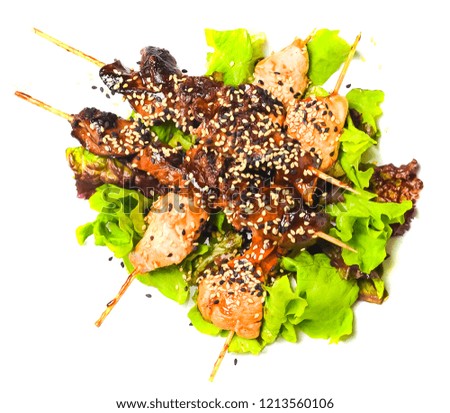 Yakitori with sesame seeds. Fried chicken meat and chicken liver on sticks close-up isolated on white background. Top view