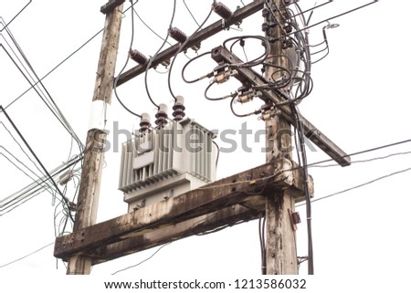 AC high-voltage power transformer. Electrical energy transfer to end users through distribution transformer on concrete pole changing high voltage to low voltage in Thailand