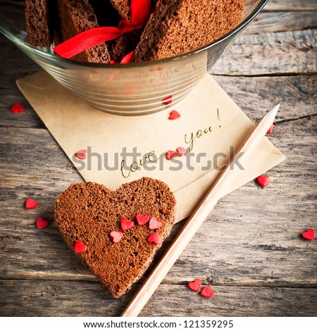 Card with Message Love You in the Letter and Chocolate Cookies in the Shape of Heart at Valentine Day Royalty-Free Stock Photo #121359295