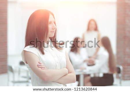 portrait of confident young business woman on office background
