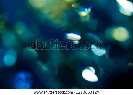 Colorful soft circular bokeh overlay for use to enhance images with copy space on a deep twilight blue background