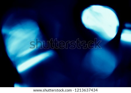 Colorful soft circular bokeh overlay for use to enhance images with copy space on a deep twilight blue background