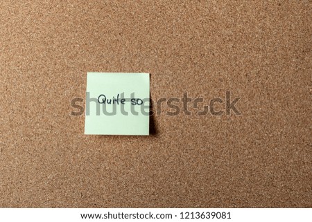 green sticker on brown table. color sticker, motivational, quote and words, note, message