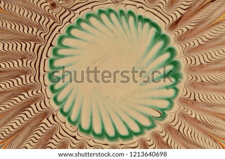 Symmetric circular abstract design of the traditional Romanian painted and glazed ceramic plate. 