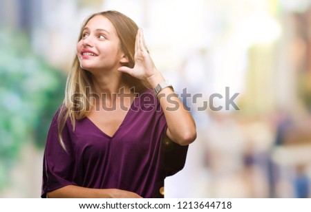 Young beautiful blonde elegant woman over isolated background smiling with hand over ear listening an hearing to rumor or gossip. Deafness concept.