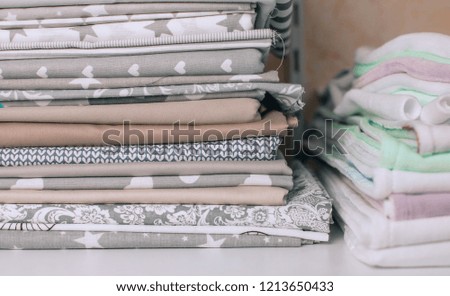 lots of bundles of different verities of new fabric in many color collections kept on the shelf of a local store in Asia 