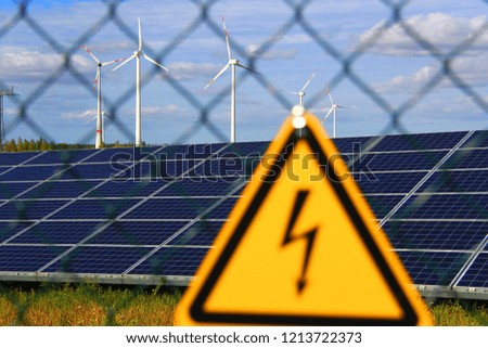 Sign of danger to the life of electricity on the fence of solar panels