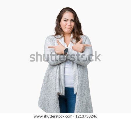 Beautiful plus size young woman wearing winter jacket over isolated background Pointing to both sides with fingers, different direction disagree