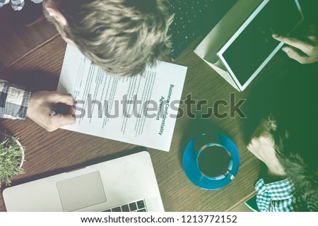 top overhead view of people with agreement documents on office working and signing