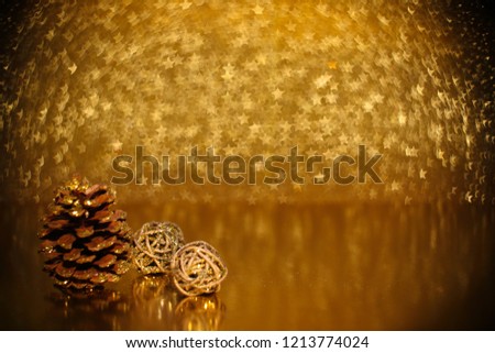 Christmas decoration of pine cones and decorative gifts golden star bokeh background