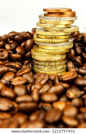 Coffee beans and money. Fair Trade. Sale of coffee. Commodity trade. Fresh coffee beans. Column of Euro coins