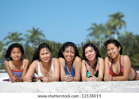 Group of ladies having fun in the sand on the beach