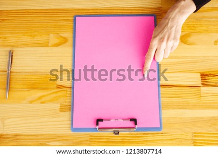 Blank Folder with Pink Paper. Hand that Holding Folder and Handle on White Background. Copyspace. Place for Text.