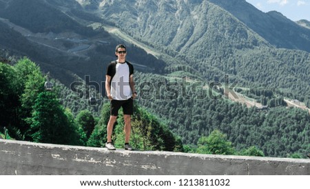 young guy on a background of mountains