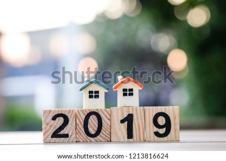 Two house model on 2019 wooden blocks number. New year property investment concept.