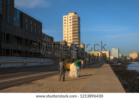 The couple are walking on Havana's boardwalk.