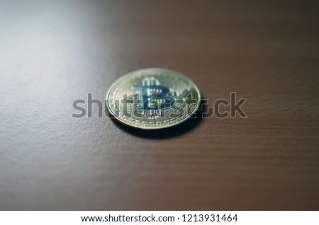 Gold Bitcoin money on wooden table. Electronic crypto currency