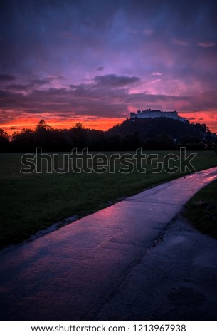 Fortress Hohen Salzburg in Salzburg at sunset with burning sky, vertical crop