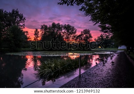 a pond in Salzburg with purple sky after the rain