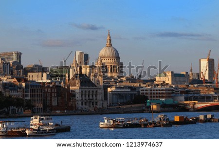 The dome of St. Pauls Cathedral across the Thames river by the early evening sun. London. united Kingdom.
