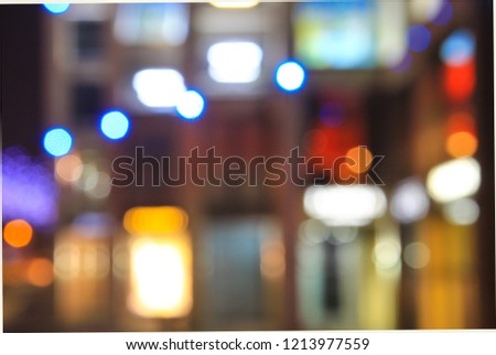 White, red, yellow . blue blurred lights of the city illuminations on the background of architecture, abstract bokeh, defocused. 