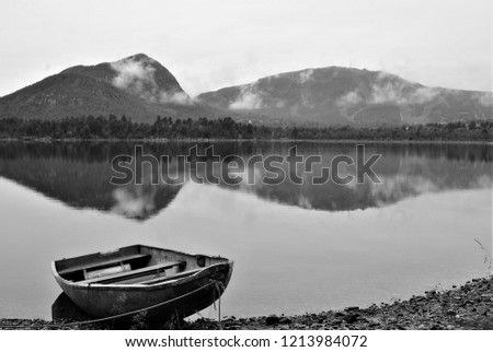 black and white picture of lake with boat in Norway