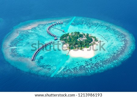 Just prior to landing at Male airport in the Maldives many small coral islands can be viewed from the plane windows.