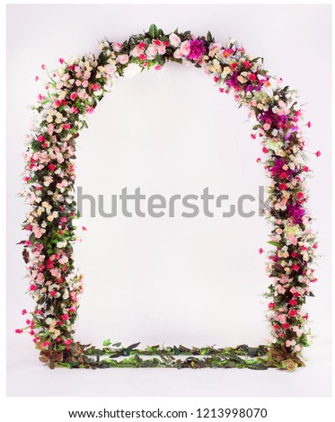 flower arch with flowers, branches and leaves Royalty-Free Stock Photo #1213998070