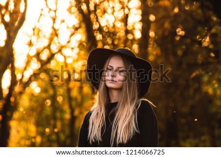 Picture of a dirl model in a forest, sunset, golden hour