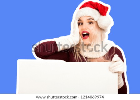 Attractive smiling young girl dressed in Santa's hat holds flipchart board and dreams about gifts. Christmas and New Year advertising concept. Magazine style fashion collage with blank copy space