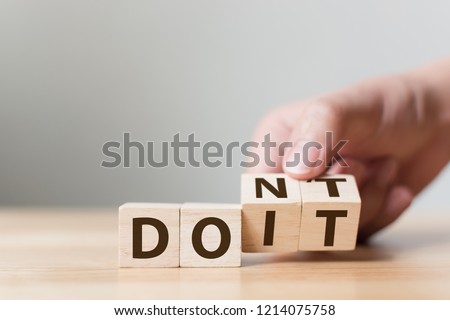 Hand flip wooden cube block with word don’t change to do it. Personal development and career growth or change yourself concept Royalty-Free Stock Photo #1214075758