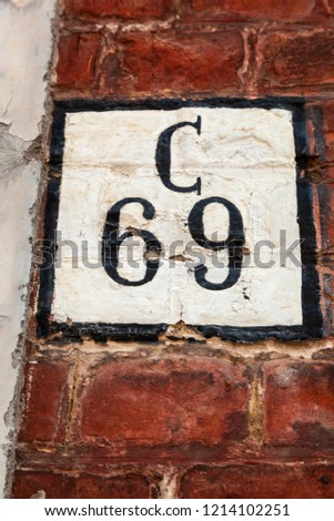 House number sixty-nine 69 painted black on white and black square on brickwork in bold modern font from Sweden