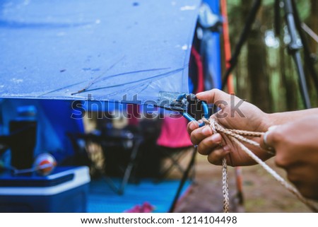 Travel nature relax in the holiday. camping on the moutainIn the wild nature. Pull the rope Carabiner.
